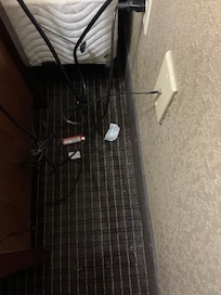 Garbage behind nightdresser