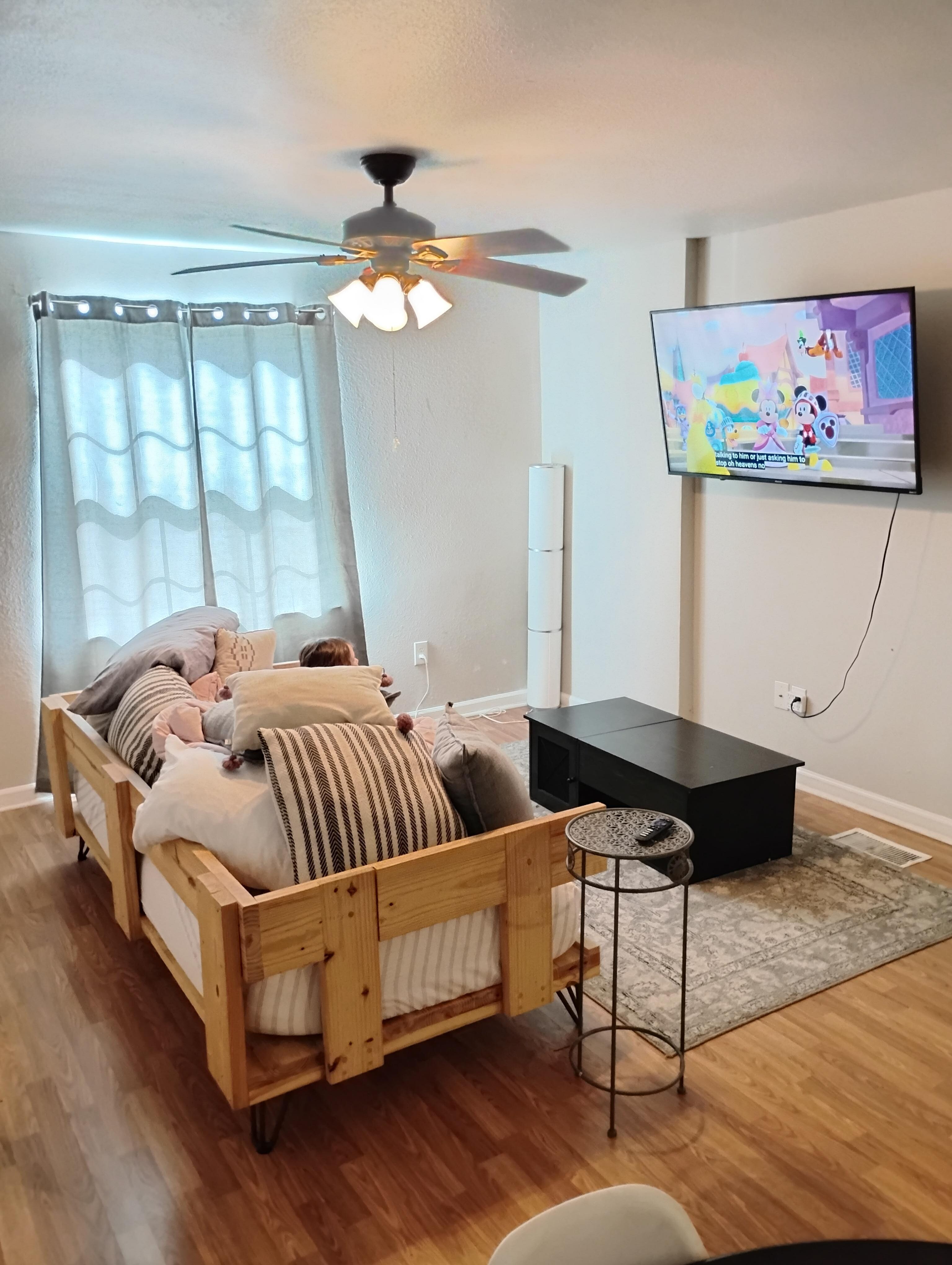 The low back daybed. The coffee table top pops up but not very high. Tall enough for a kid to fit under.