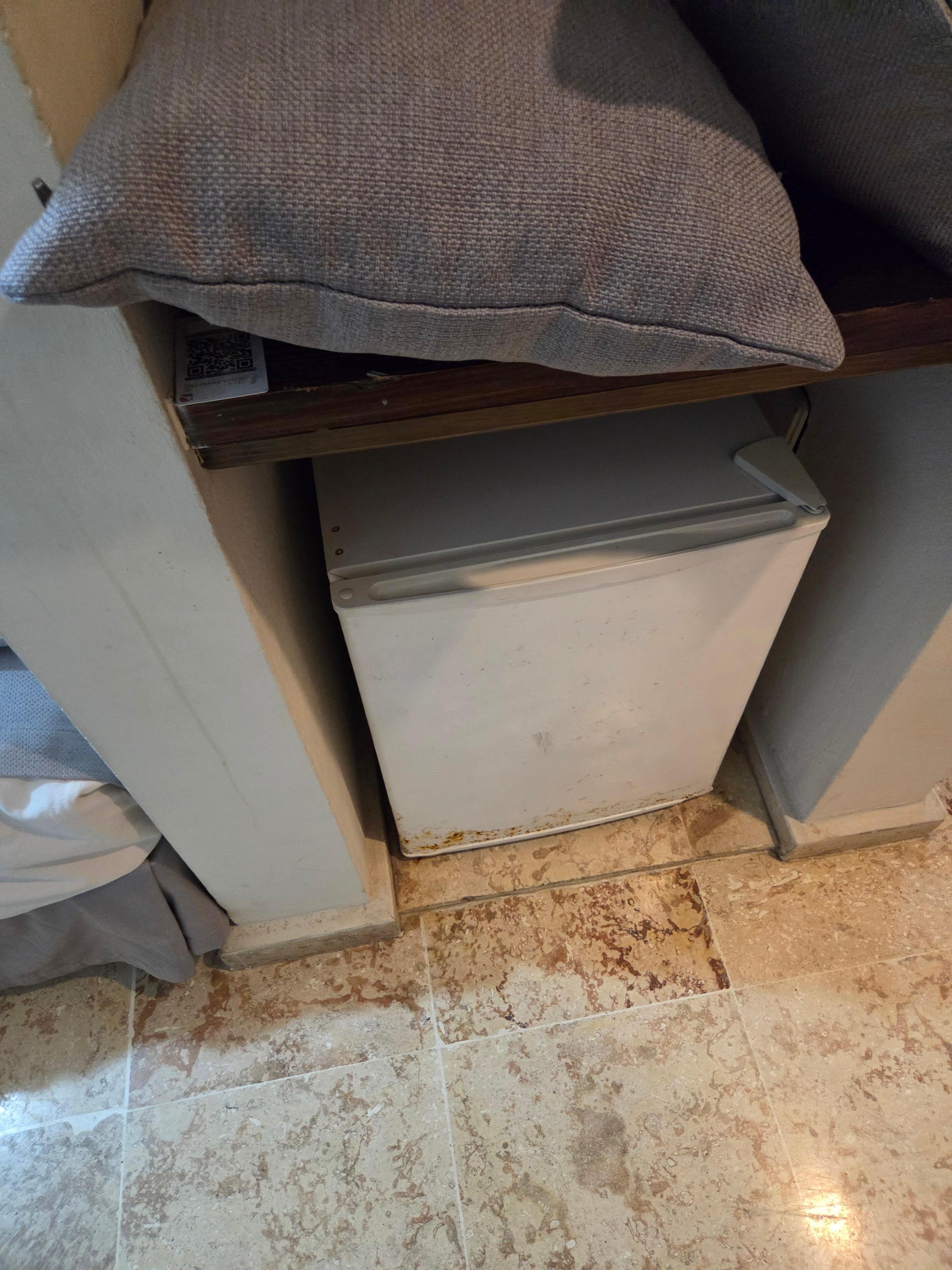 Joke of a mini bar in a dirty fridge with only 2 beers