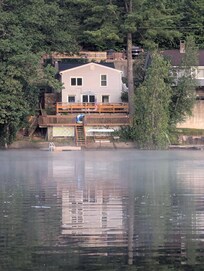 Western side of house, hill, house and trees provide afternoon shade over the decks and floating platform.