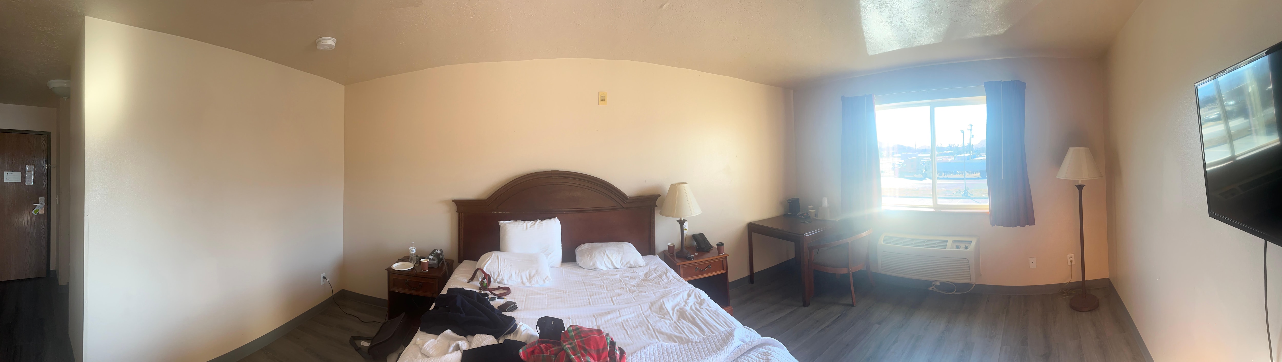 Except for the mirror and TV, a solid length of blank wall. 