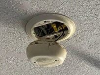 Smoke detector hanging from the ceiling