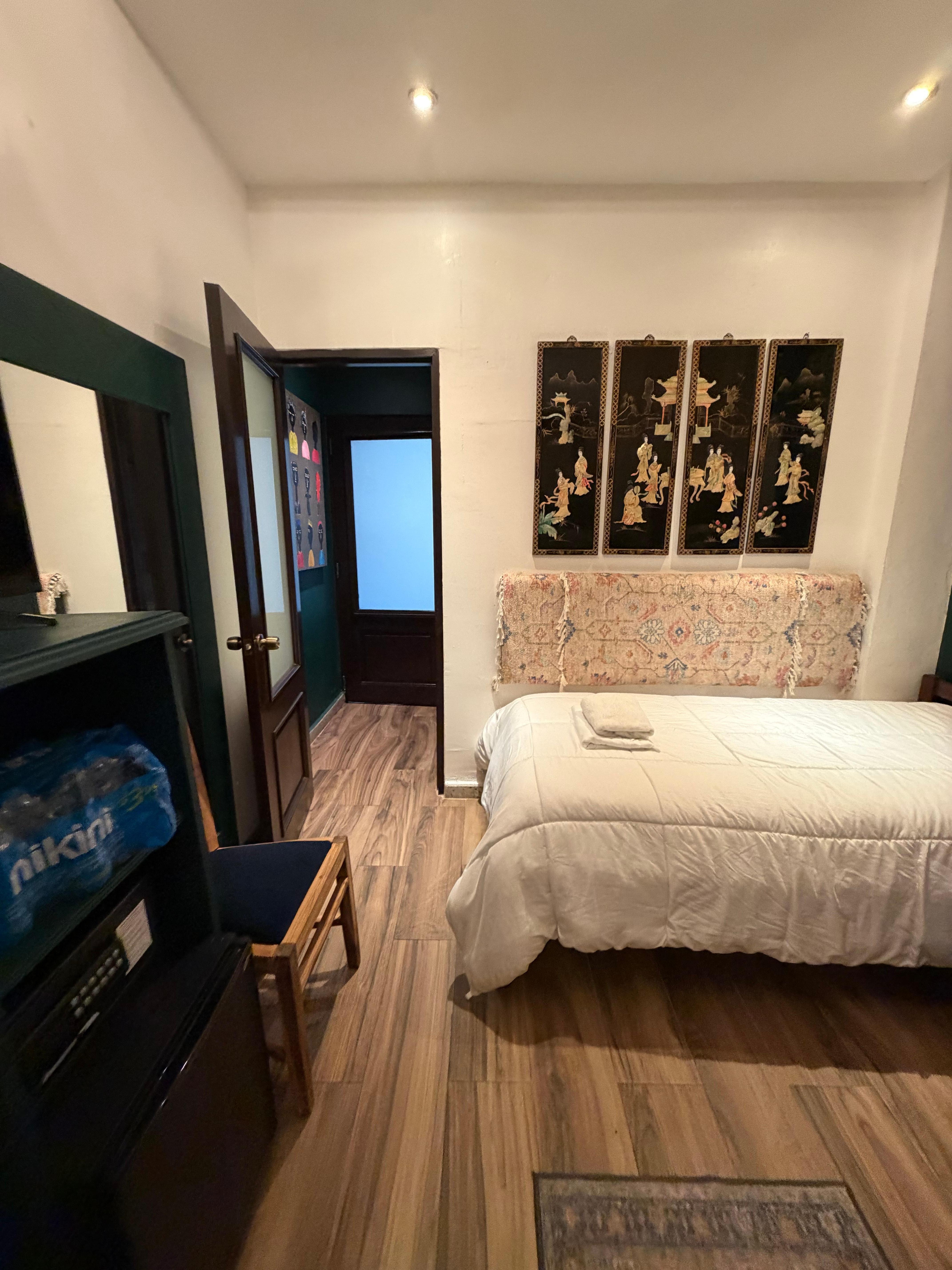 Door connecting to other room. Bathroom in between the two rooms. 