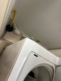 Used toilet plunger and brush next to the washer and dryer closet.