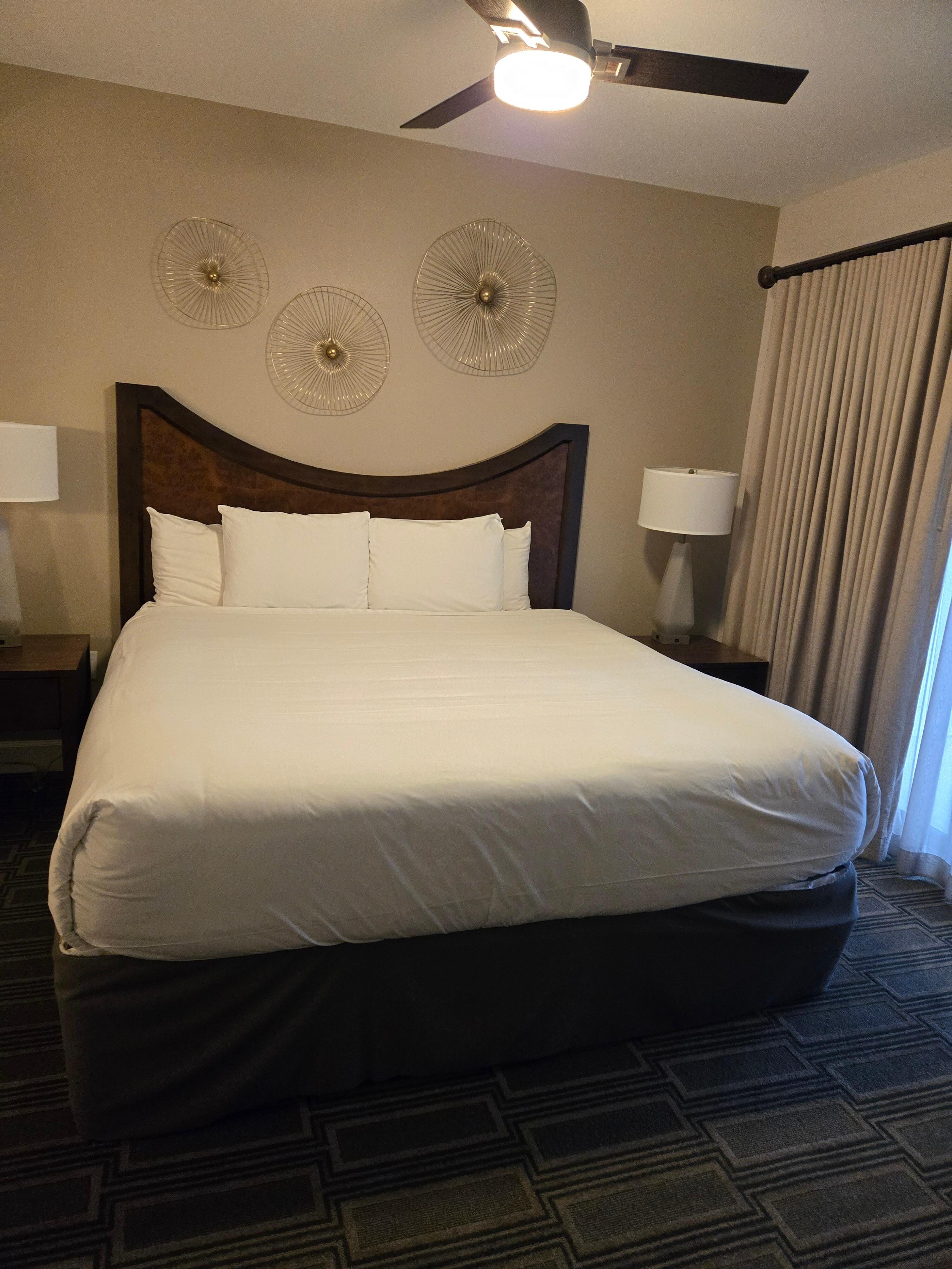 King size bed with dresser and closet. Also, access to the balcony