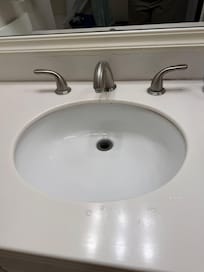 no drain stopper; original countertop and cabinet