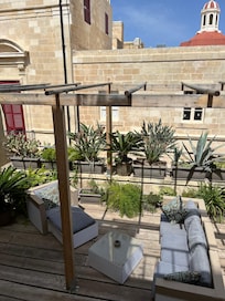 Terrace with lovely sitting area and beautiful plants.