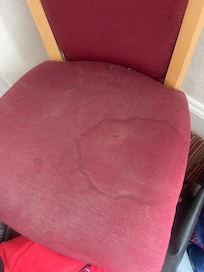 Old Stained chair in room