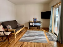 Additional living space with TV and comfortable futon. Sliding doors to patio.