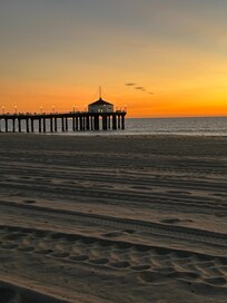 View of the Manhattan Beach Pier at sunset from the beach area in front of the property.