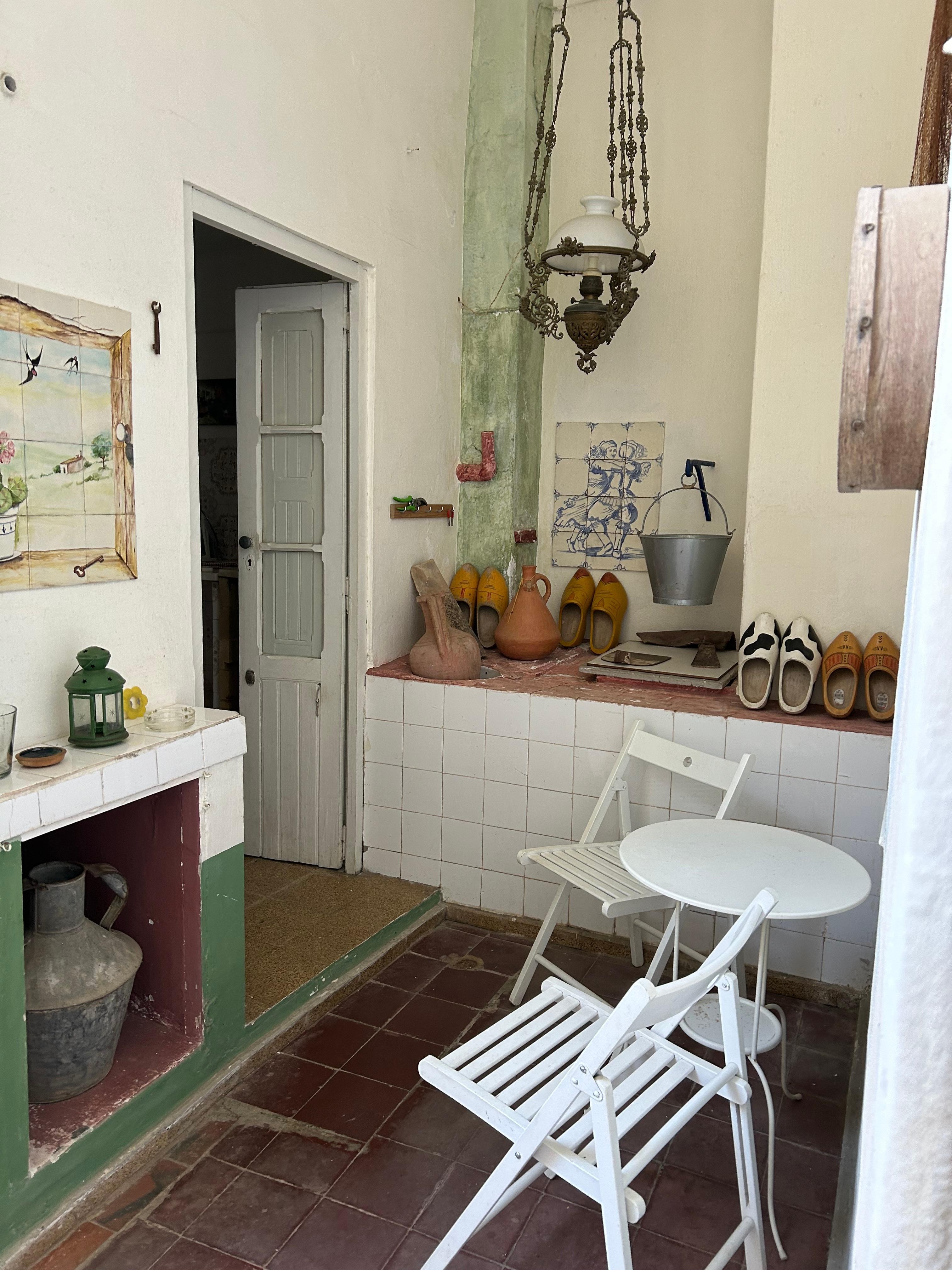 Chair nd table by back door and well. Door visible to well equipped laundry room.