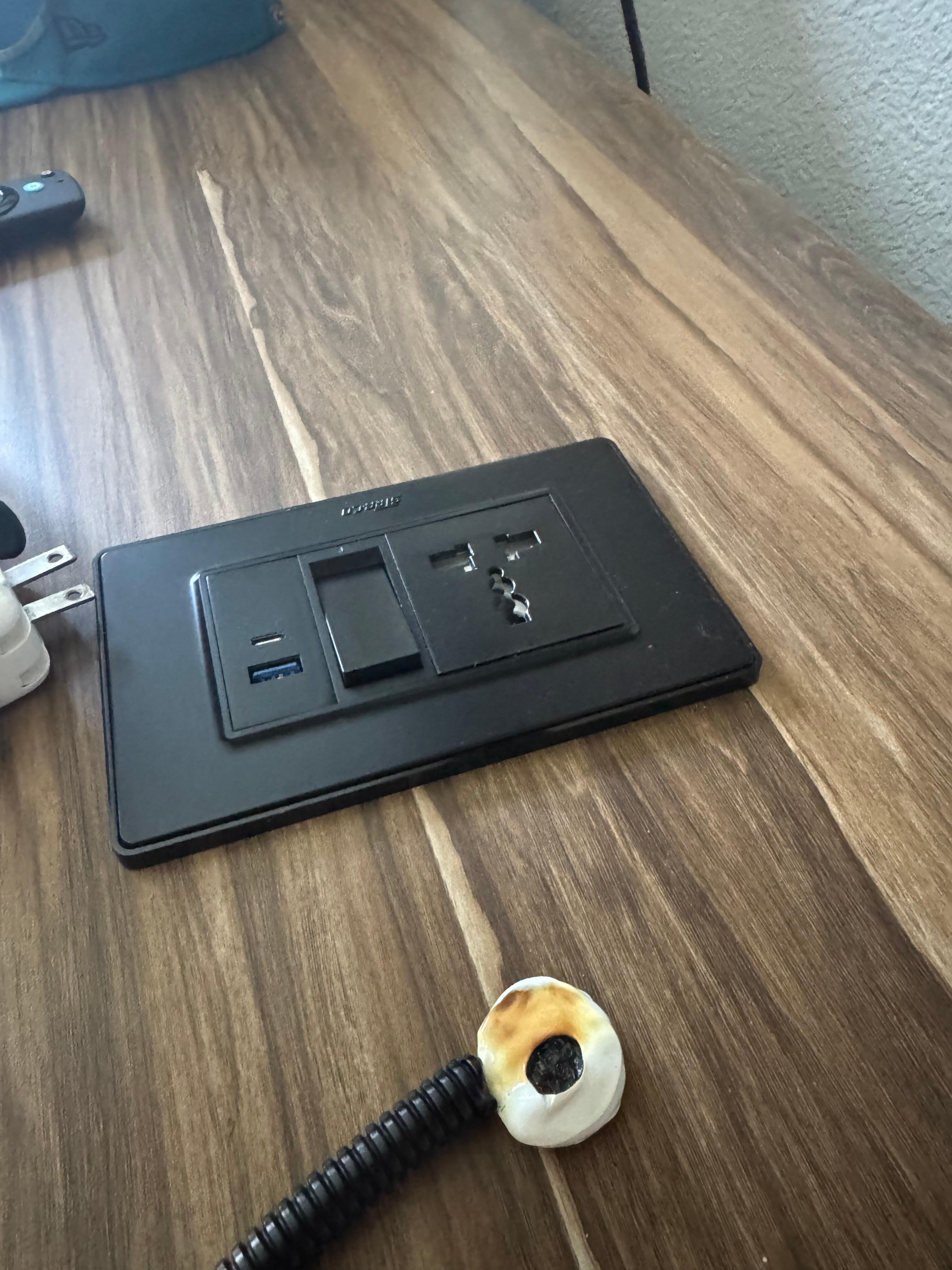 Melted charger by charging station in room