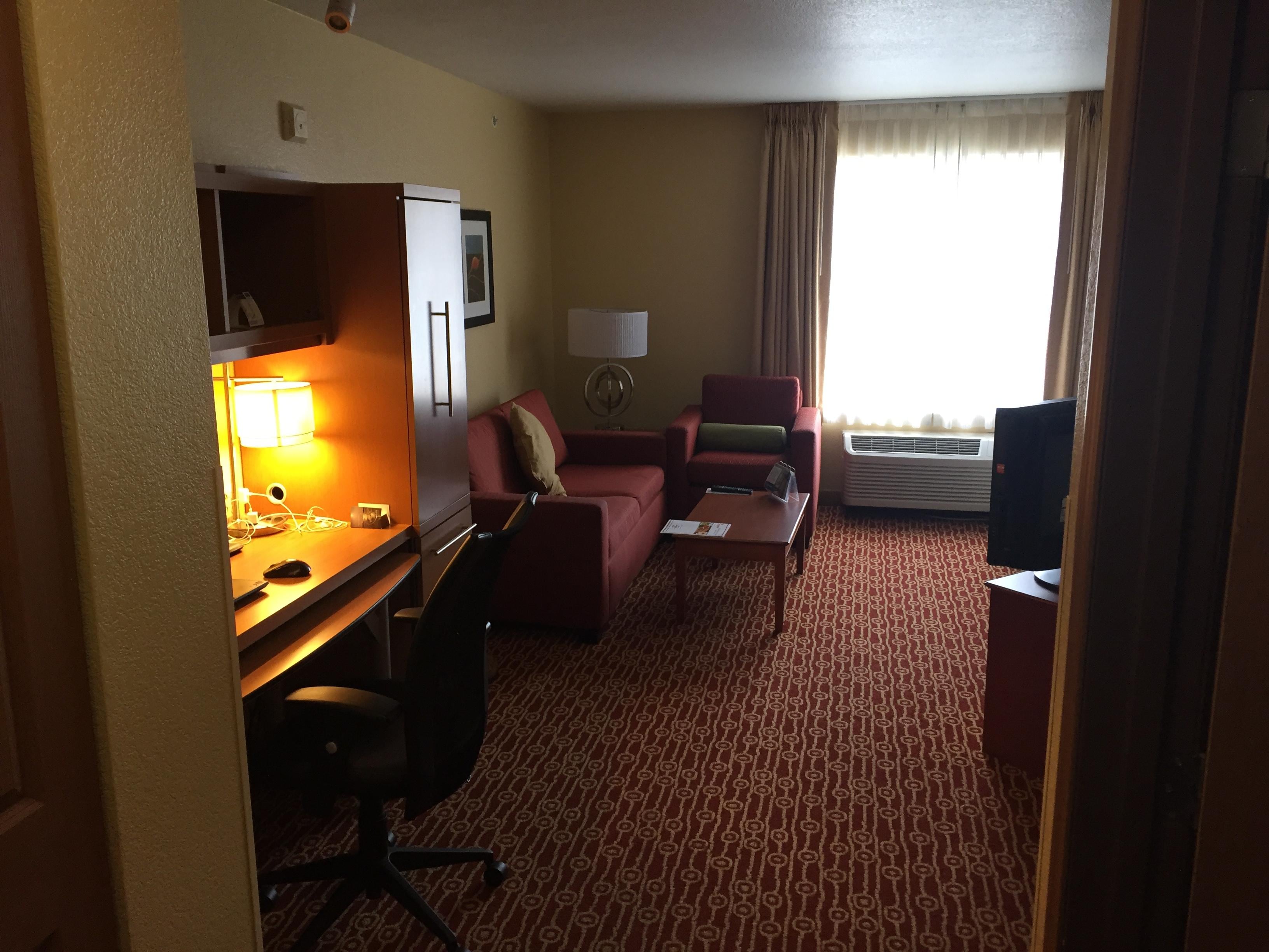 View of the bed, TV, kitchen on the right