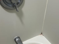 Faucet had soap, scum and corners of shower brown buildup