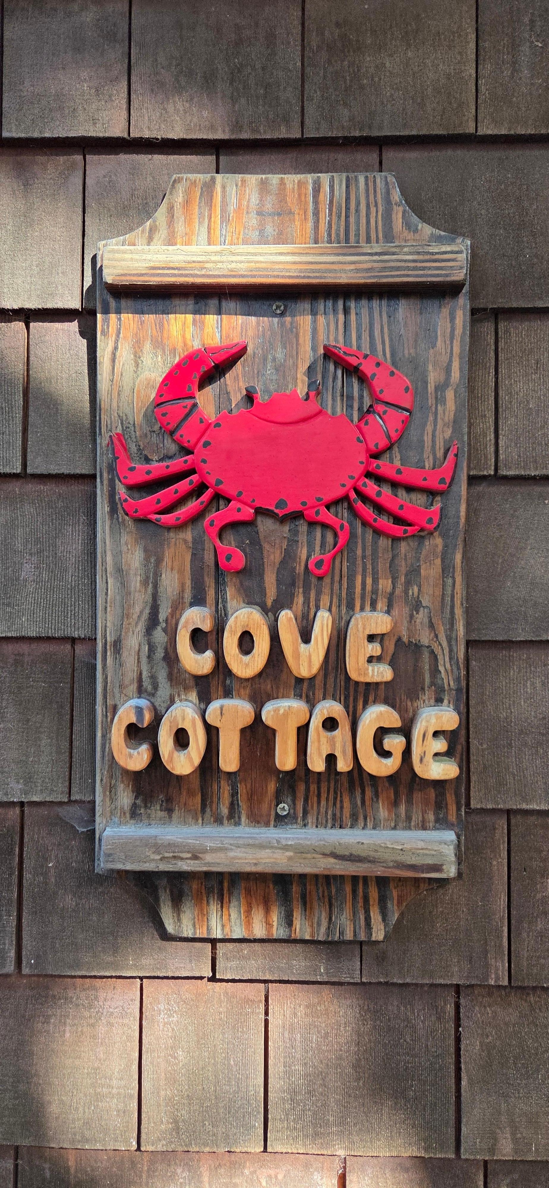 Cute Cove Cottage sign by the front door.