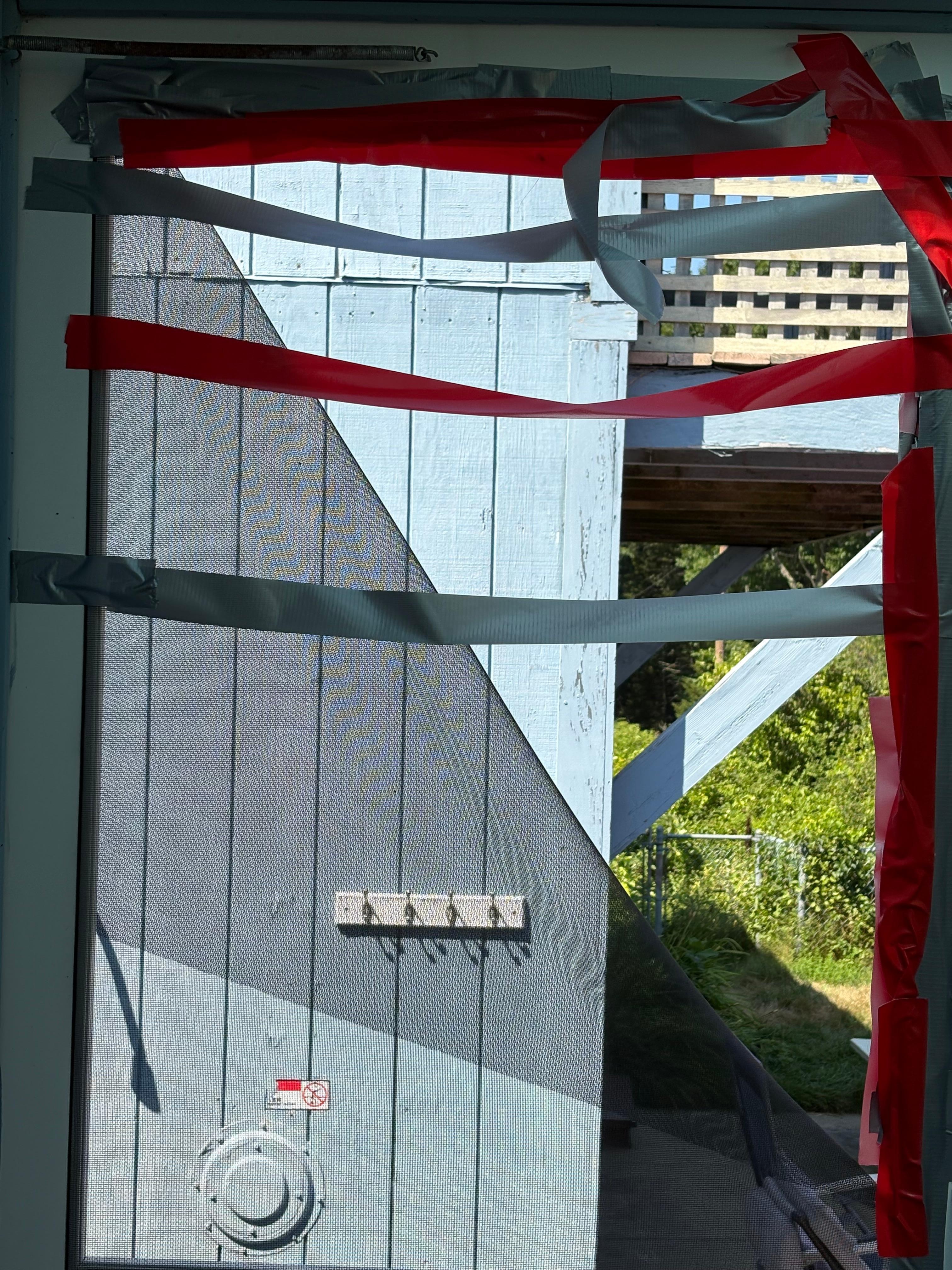 door to the pool area with screen duck taped and still falling apart