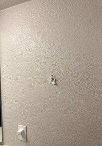 Holes on the wall covered with what seemed like toilet paper.