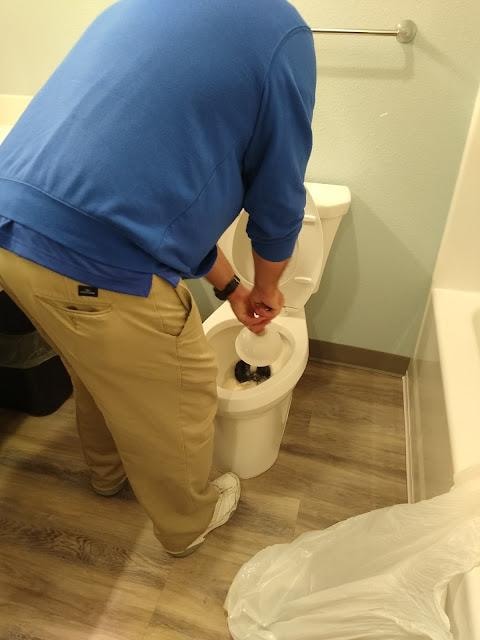 Plunging our own toilet after asking for it to be taken care of 3 time!