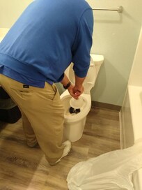 Plunging our own toilet after asking for it to be taken care of 3 time!