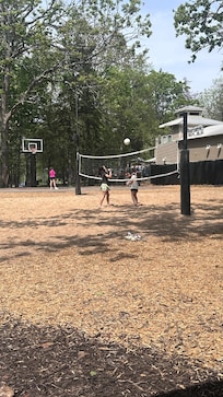 Volleyball courts with balls to play with already at the court.