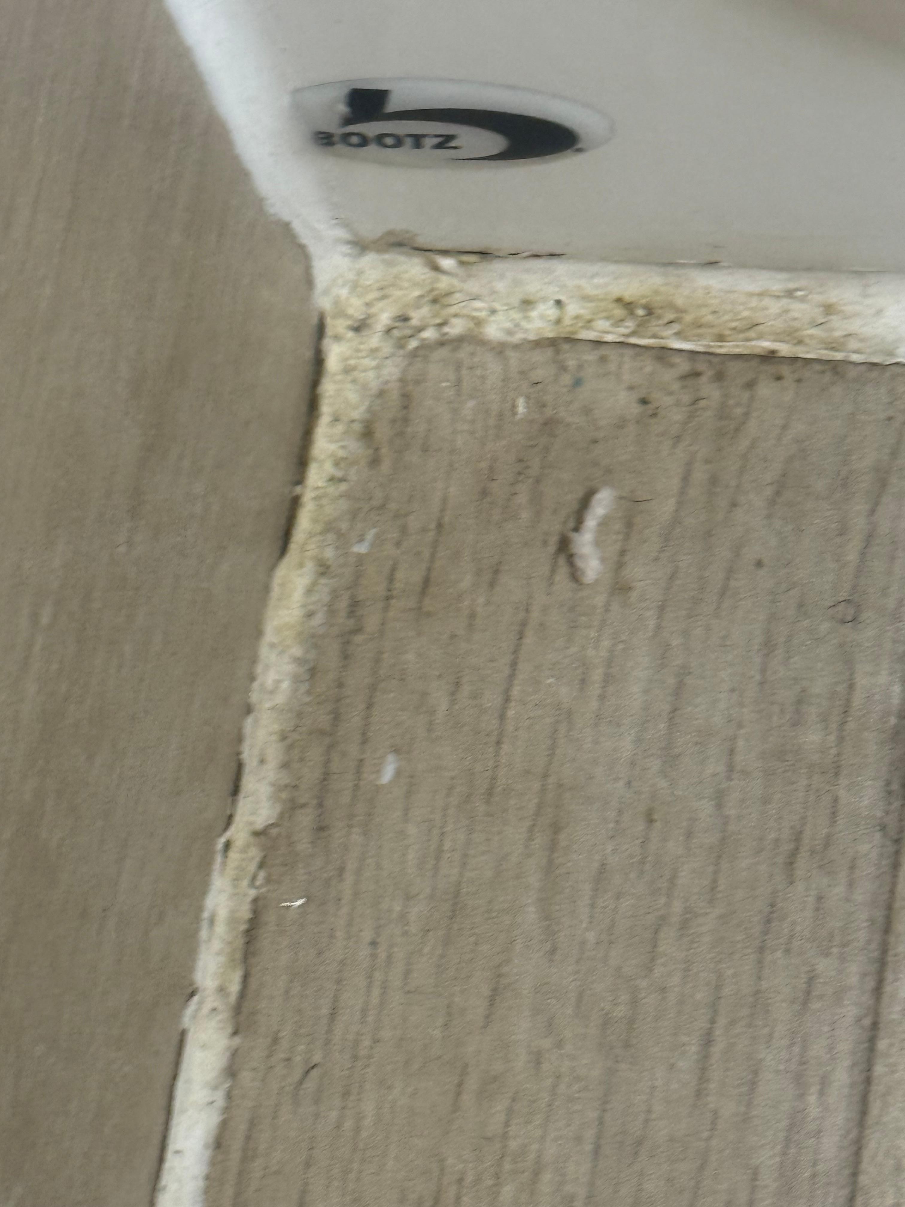 Along bath tub and floor