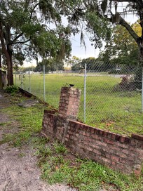 The yard/partial brick fence
