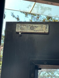 Safety was an issue. This is the front door (street) that should be locked. Found that it was not locking due to safety pin blocking magnet. Person sleeping on lobby sofa.