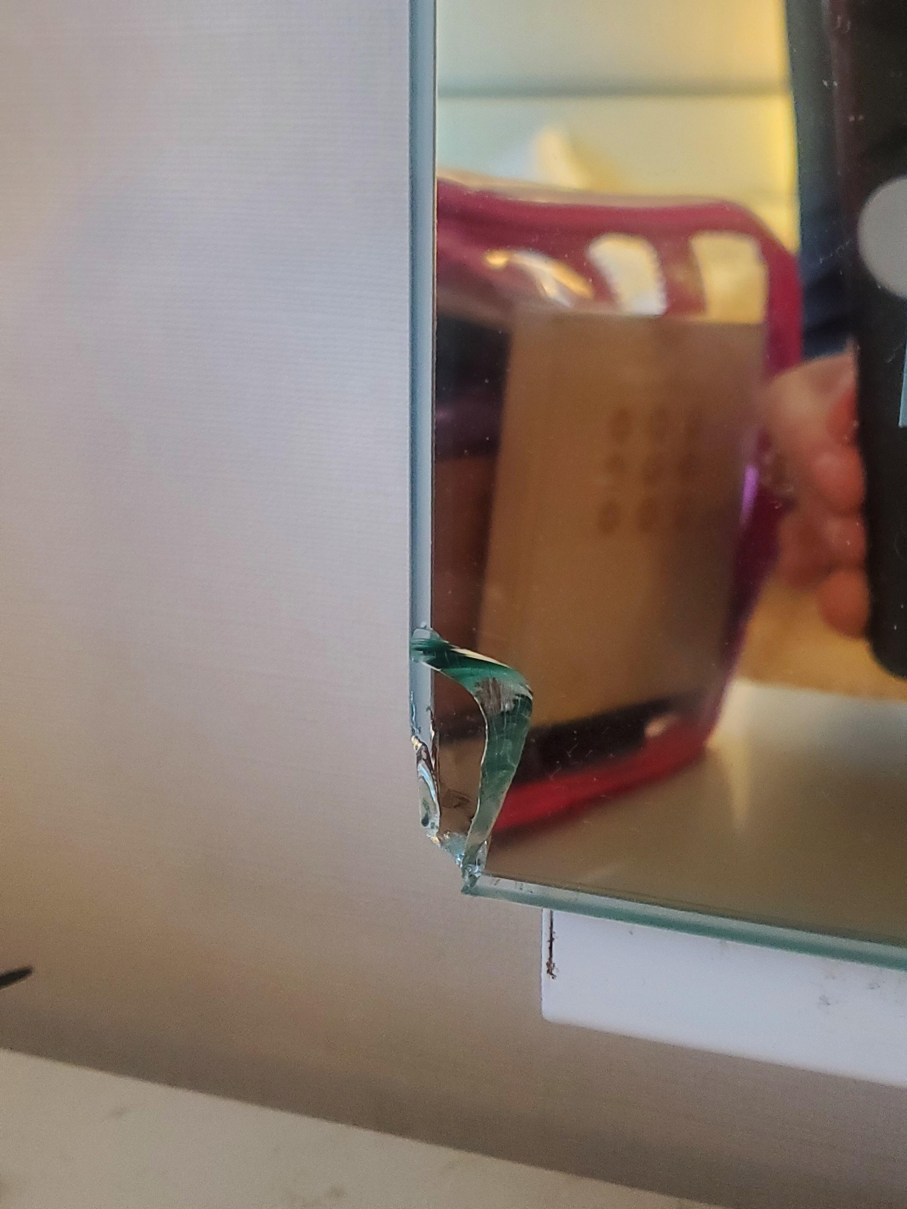 Opposite corner, same vanity mirror. Broken mirror with jagged glass..we put tape over it because there were loose shards. The light in the mirror did not work either.