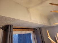 Apparent repair attempted but not completed to ceiling/wall. Mudded, but not painted.