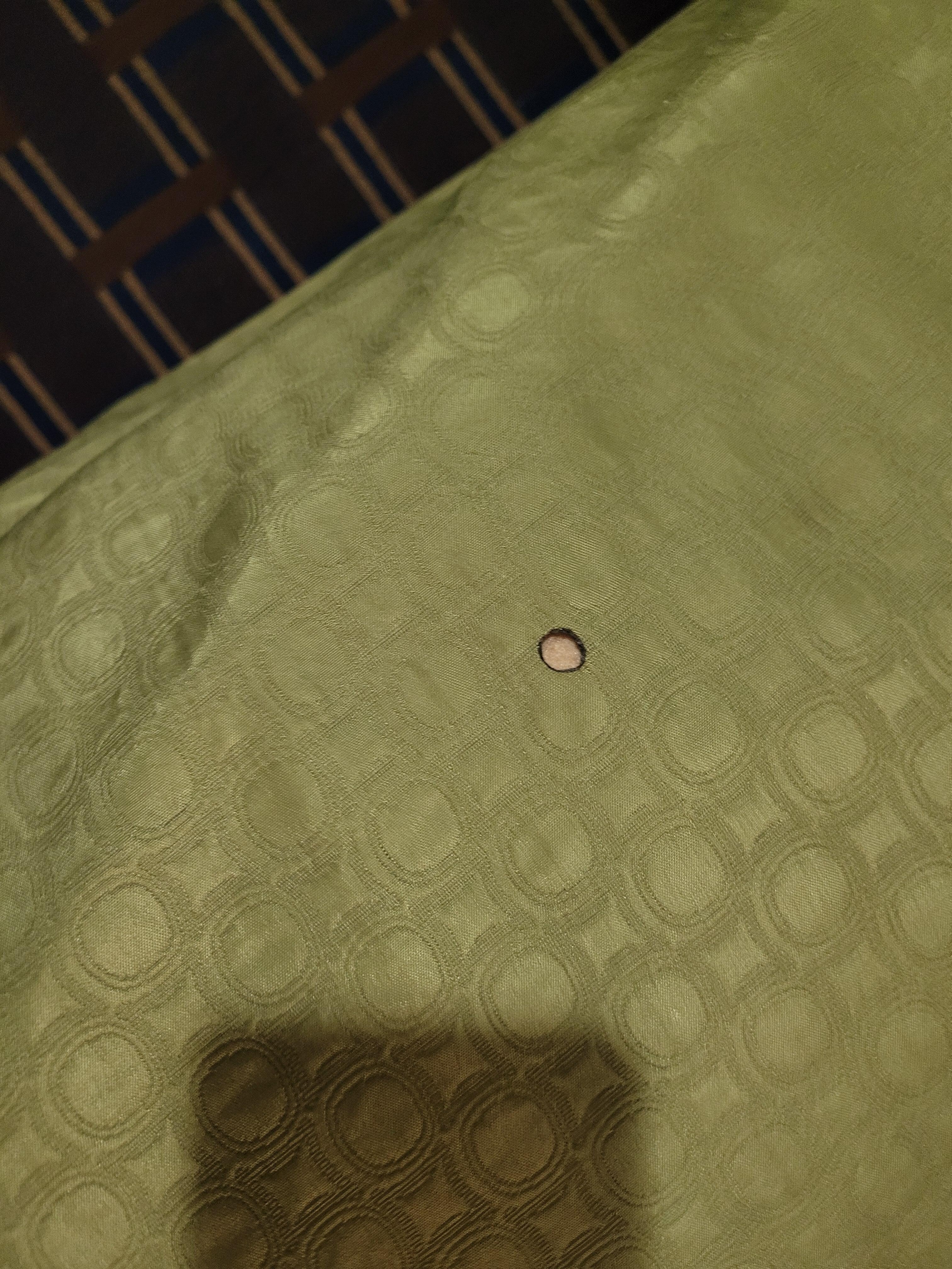 Cigarette burn on bedspread in "non smoking room".