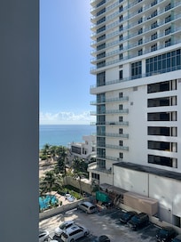 View from patio angle, patio faces next door parking garage and overlooks open parking lot of our valet & self park (when not busy)