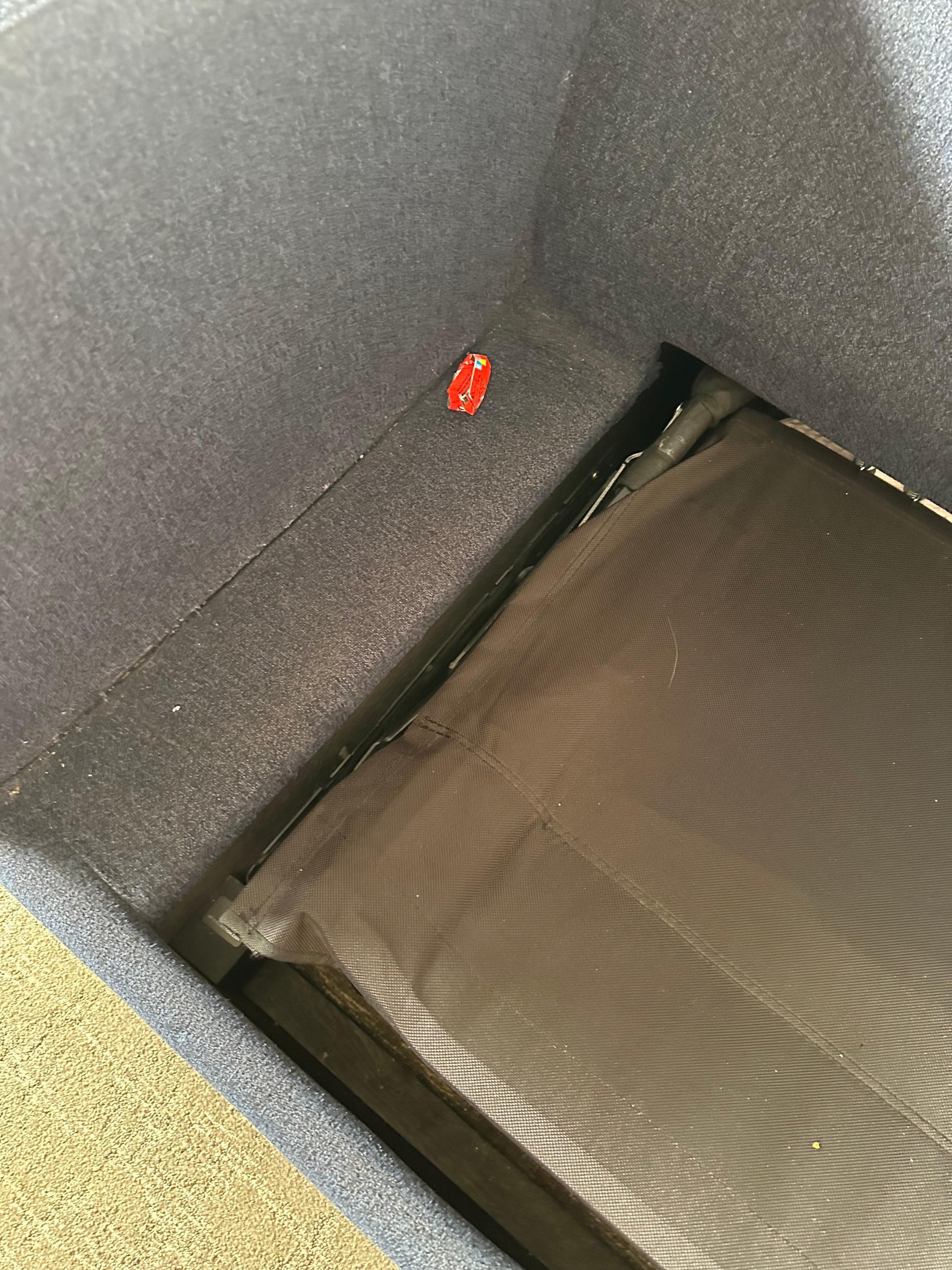 Wrappers left on sofa bed 