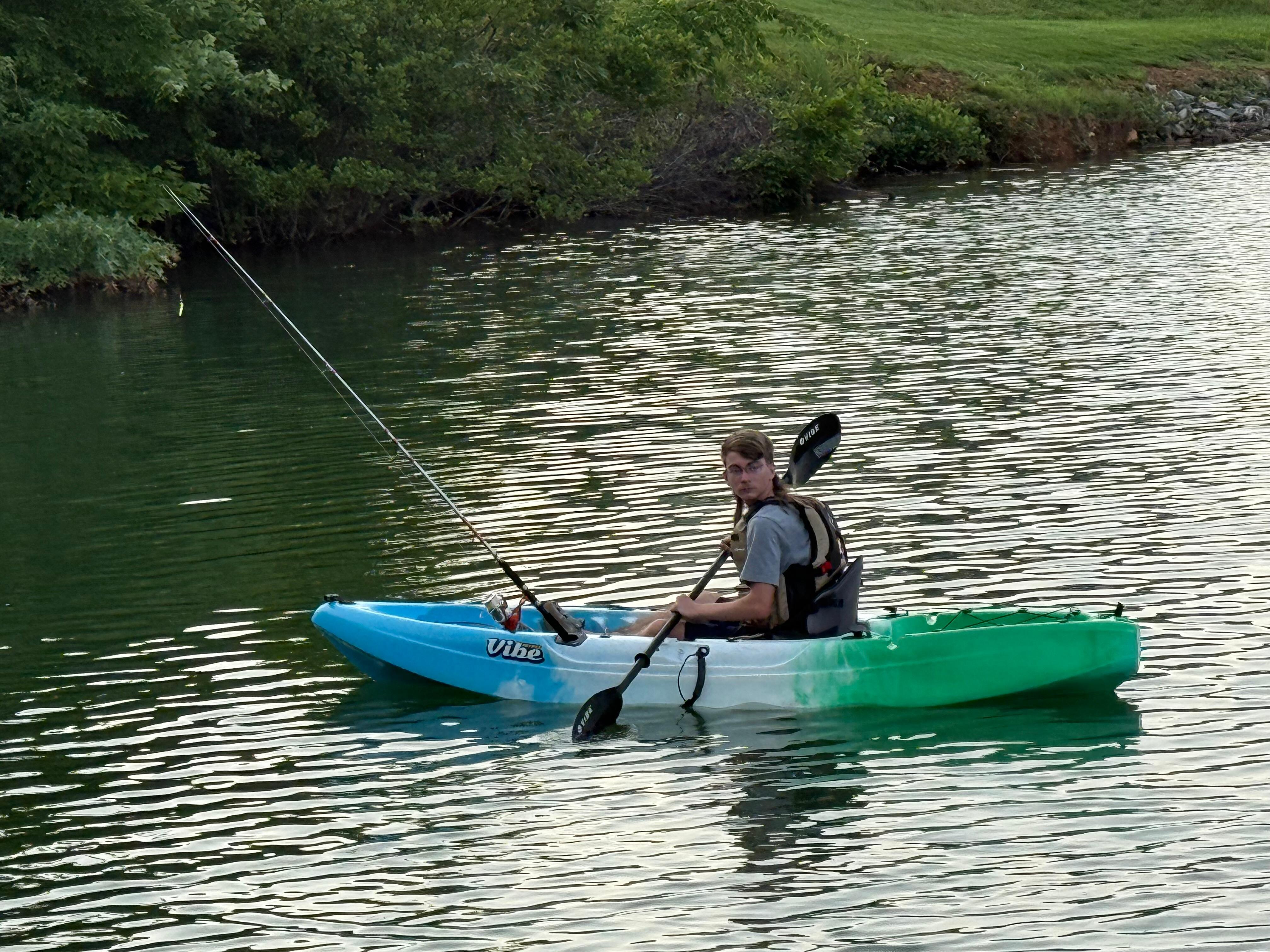 My son Kayaking and fishing. 