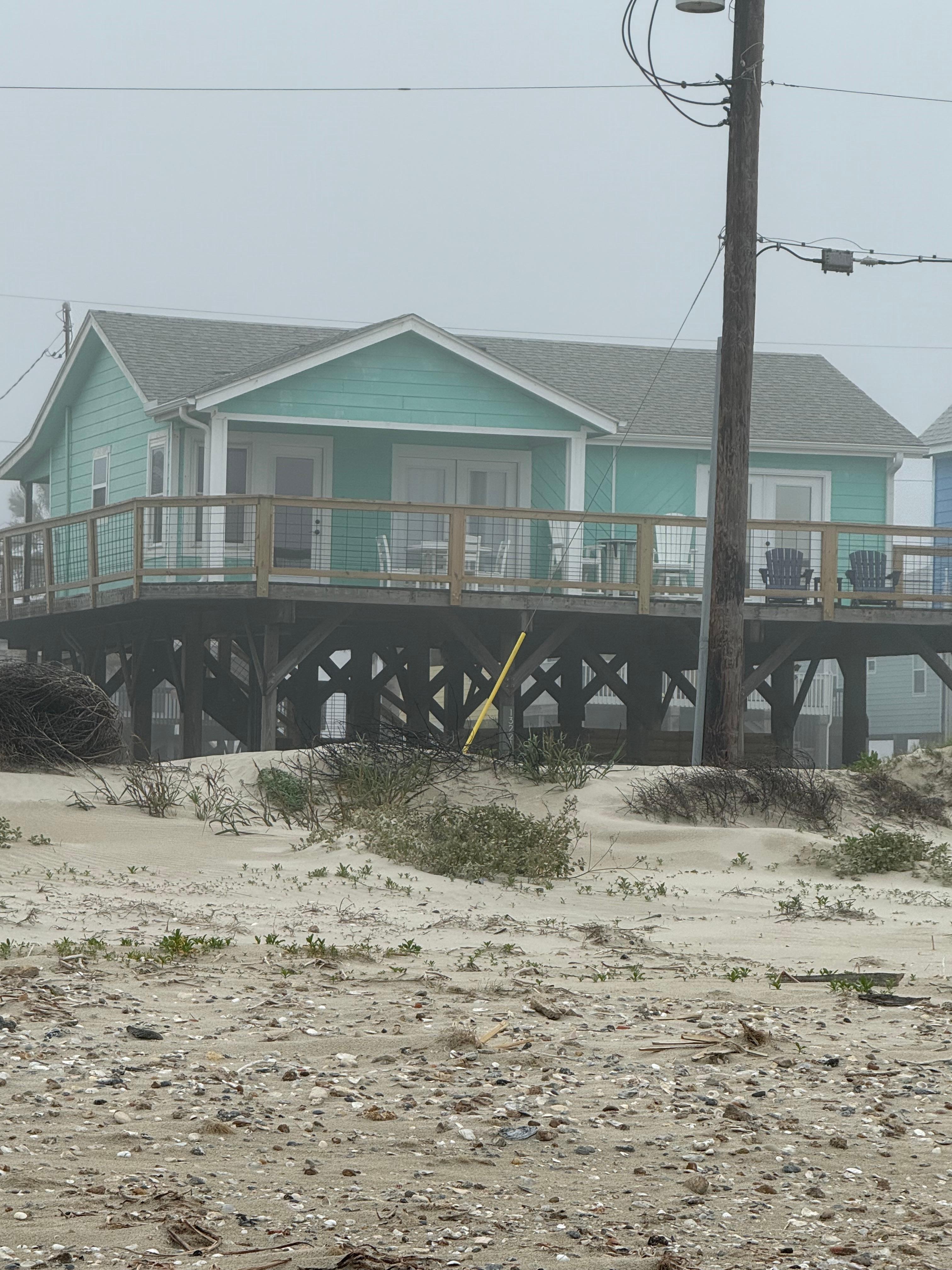 House from across the street at the water’s edge. 