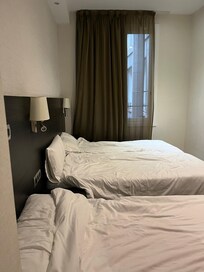 Basic 3-bed room for 3 adults. This is the extent of the room, plus a bathroom with a rather impractical frosted glass door that had gaps open to the room. Beds are comfortable; tv and desk and small closet area with safe.