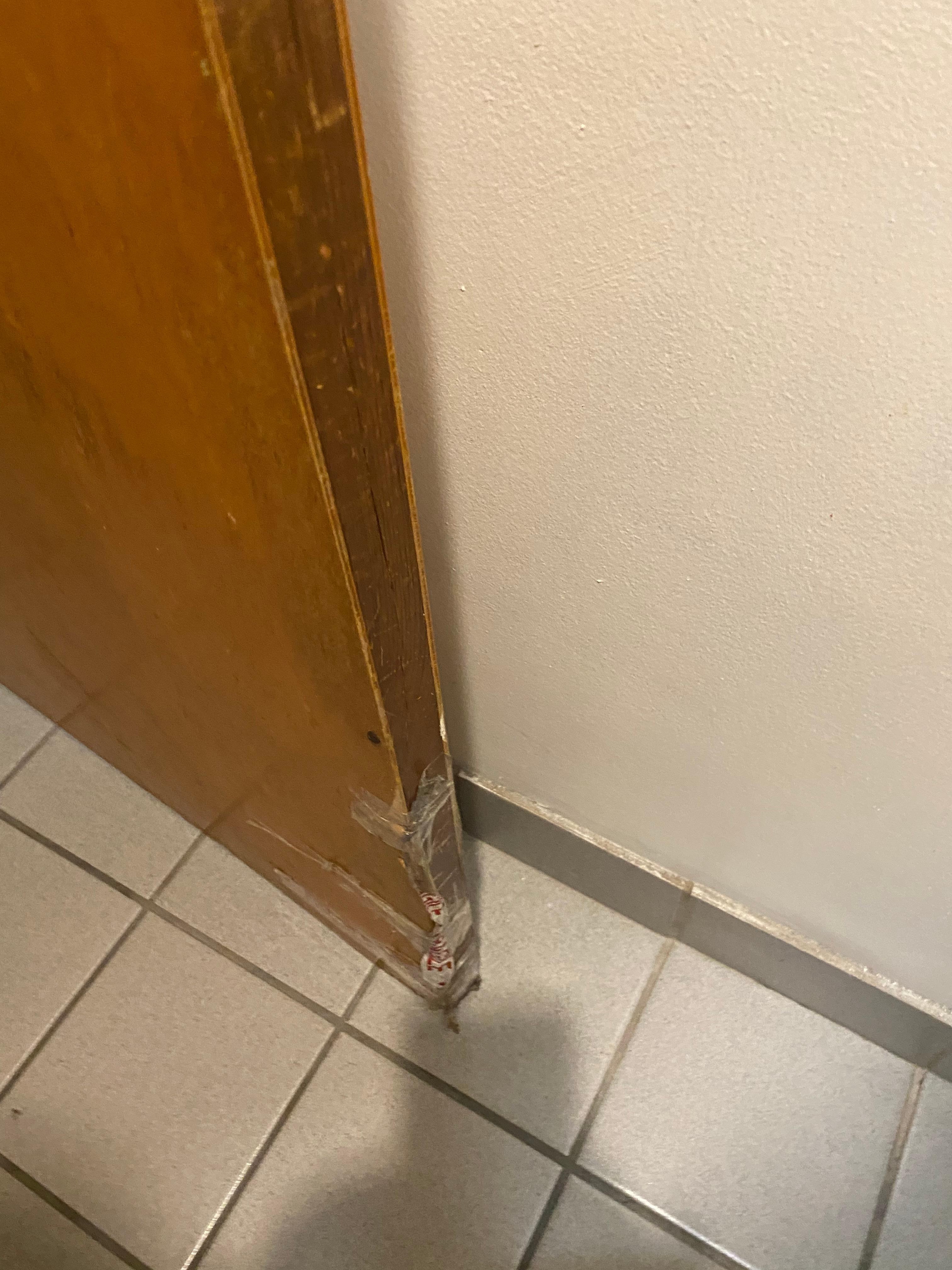 Broken door taped back together