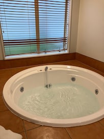 This is taken from the master bed - there is no wall or curtain or anything. You sit on the bed and look at the person in the spa.