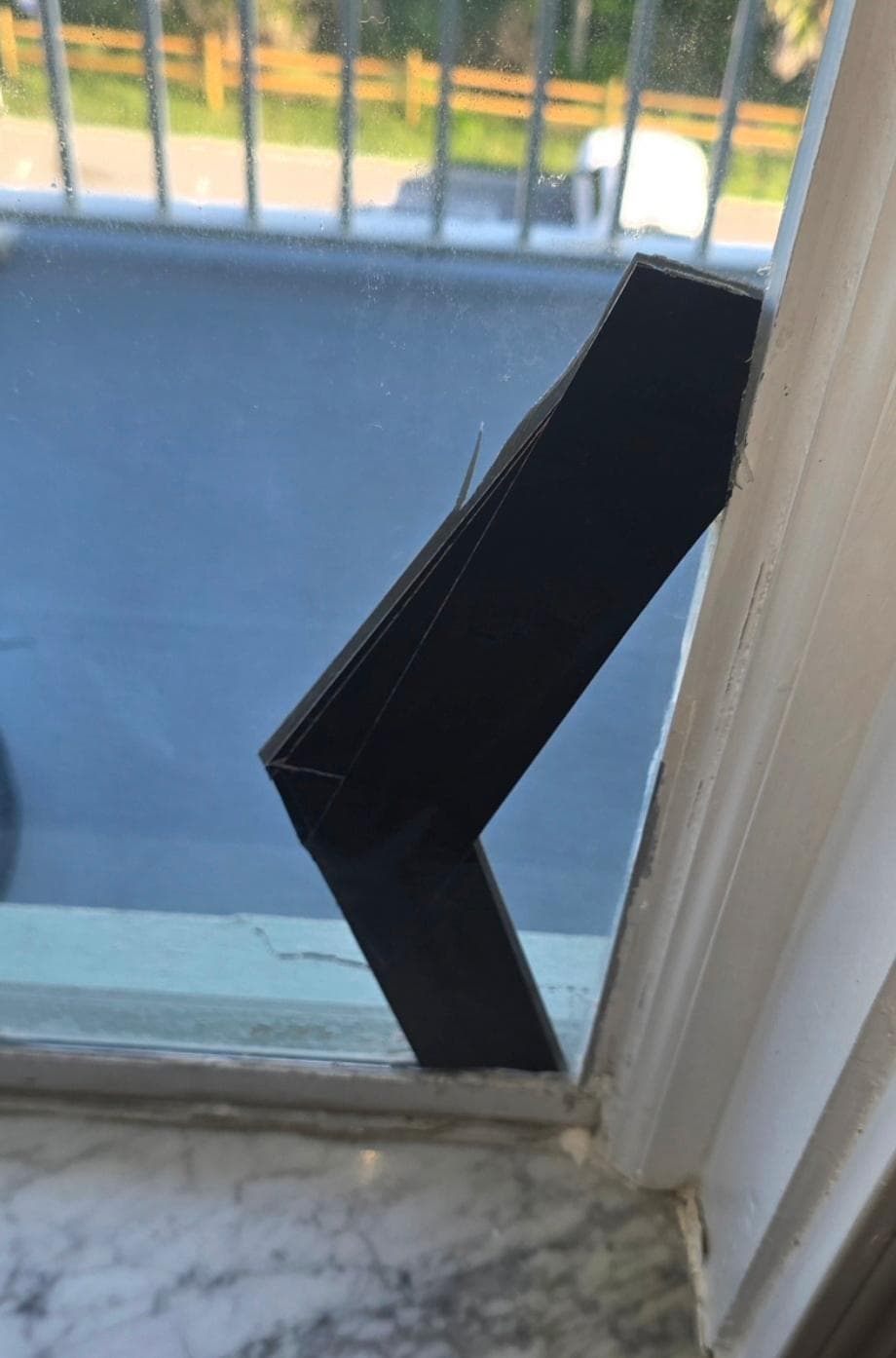 Broken window with tape on it
