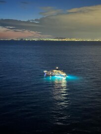 A yacht parked outside our window at night