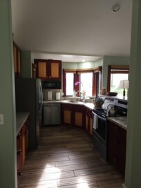 Spacious and well equipped kitchen with beautiful wood cabinets