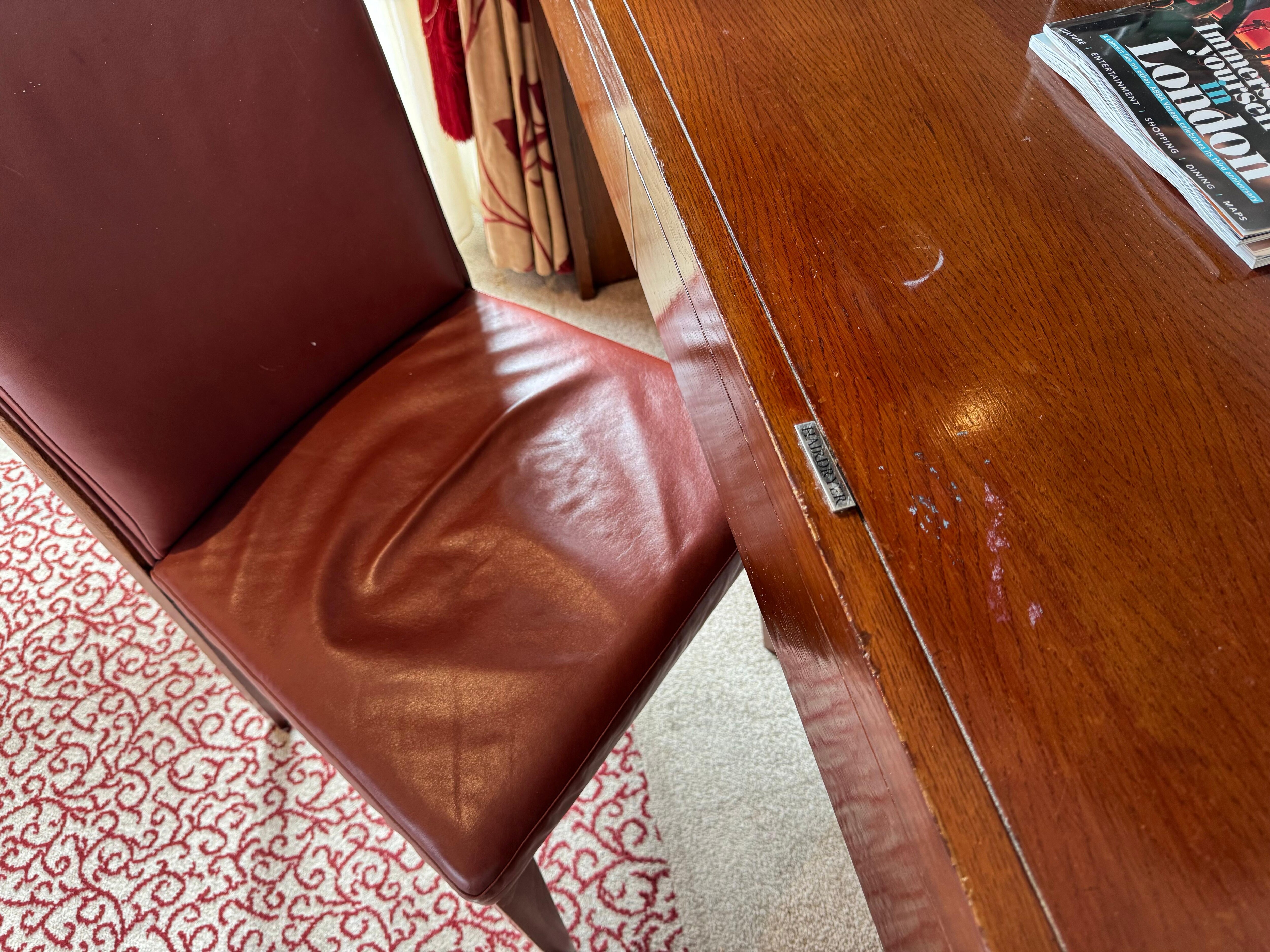 Desk and chair showing scratches and wear on both surfaces
