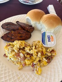 Free breakfast, scrambled eggs with bacon, plantains and rolls