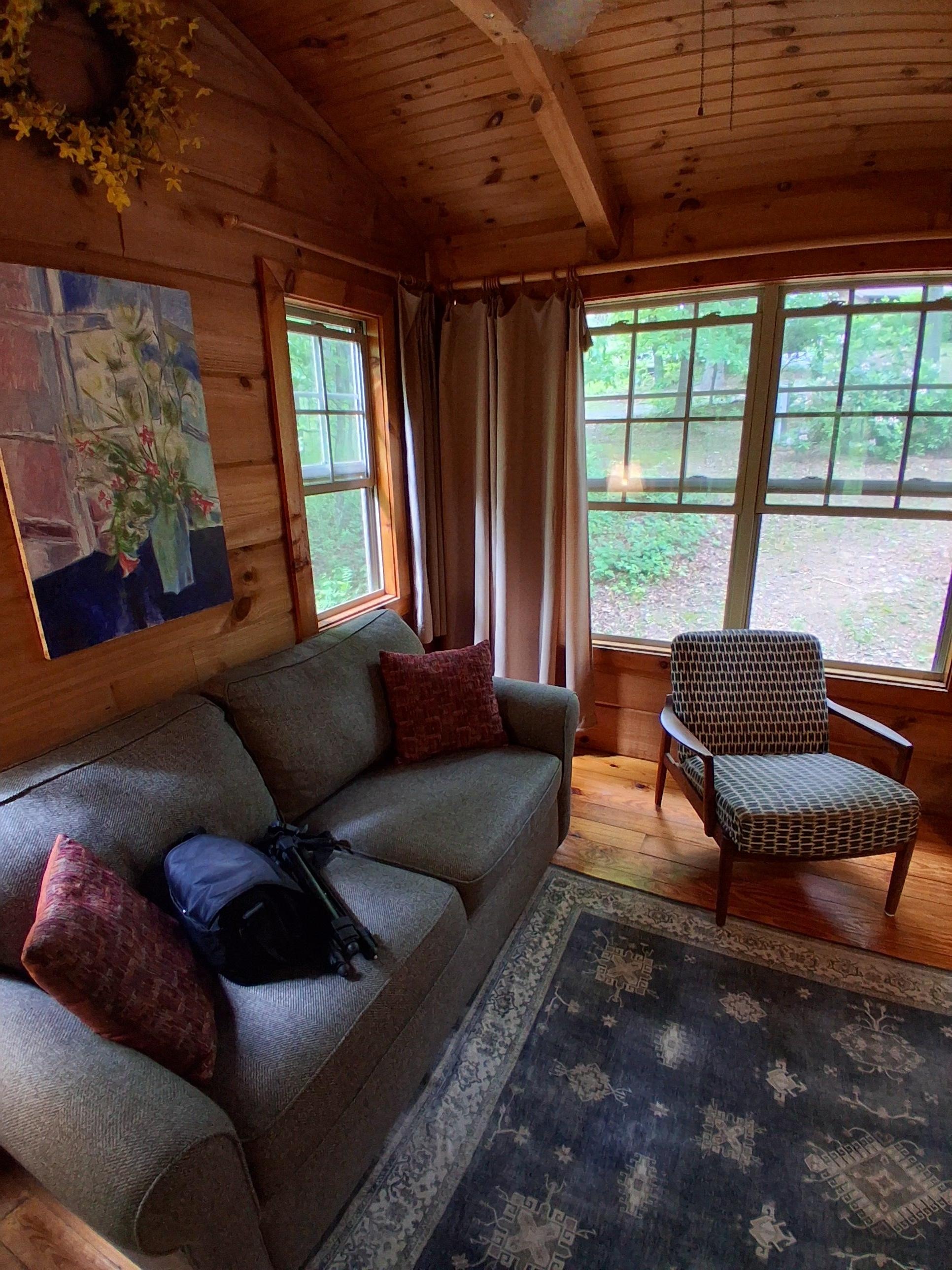 The living room has really high ceilings and comfy furniture.