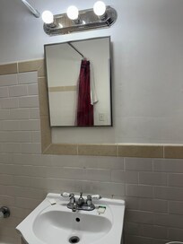 The mirror, light fixtures, and bathroom condition was dirty.