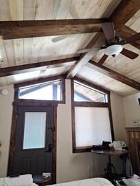 Living room front door,  window, and ceiling.