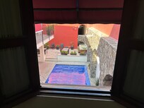 view of courtyard and pool from room