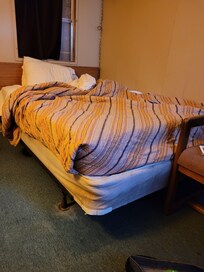 Boxspring was actually worse at the head of the bed, also broken glass above headboard.
