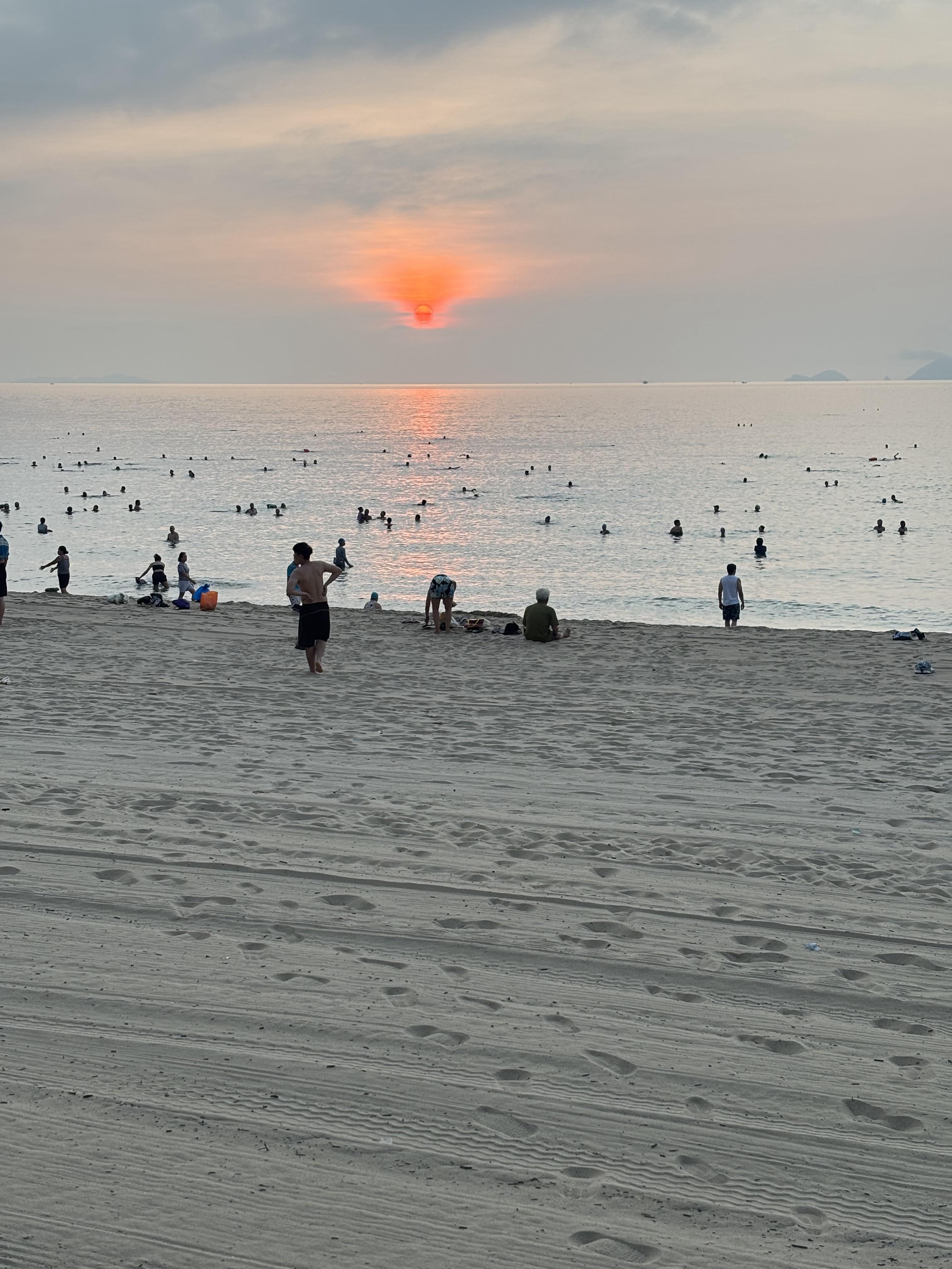 Sunrise at the beach finds the many early risers enjoying a swim before starting their day.