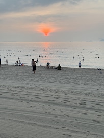 Sunrise at the beach finds the many early risers enjoying a swim before starting their day.
