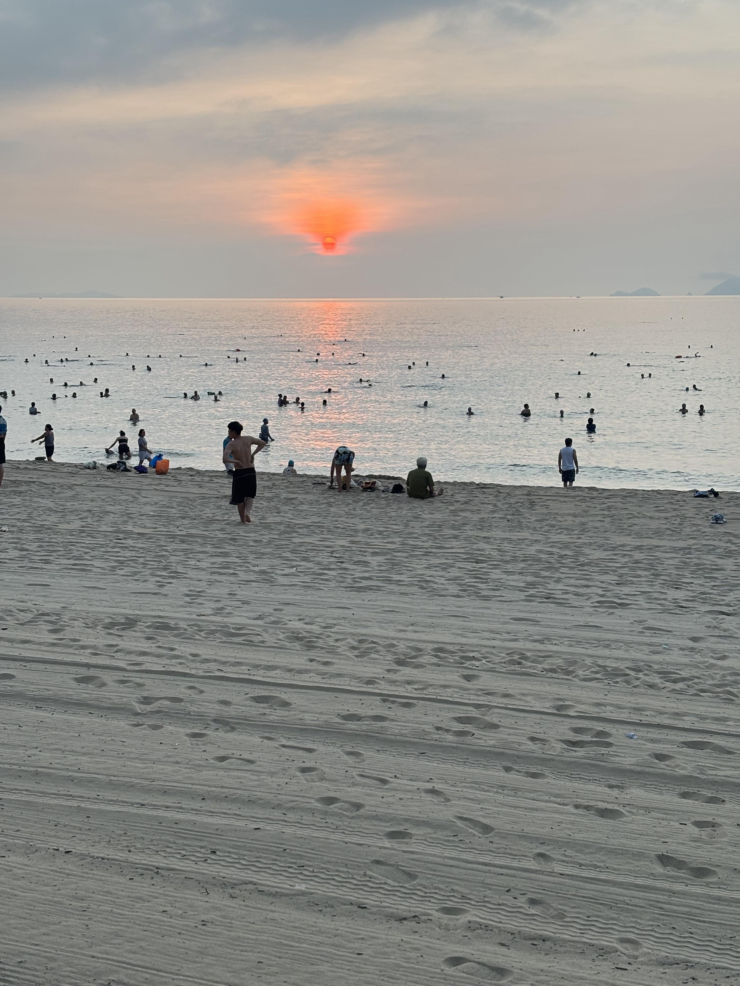 Sunrise at the beach finds the many early risers enjoying a swim before starting their day.
